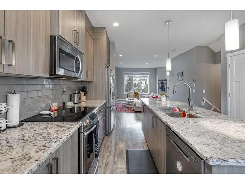 13 Willow Green Way, Cochrane, AB - Indoor Photo Showing Kitchen With Stainless Steel Kitchen With Double Sink With Upgraded Kitchen