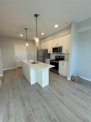 414-660 Shawnee Square Sw, Calgary, AB - Indoor Photo Showing Kitchen With Double Sink