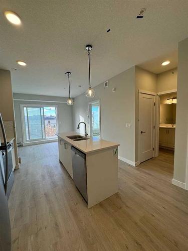 414-660 Shawnee Square Sw, Calgary, AB - Indoor Photo Showing Kitchen With Double Sink