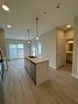 414-660 Shawnee Square Sw, Calgary, AB  - Indoor Photo Showing Kitchen With Double Sink 