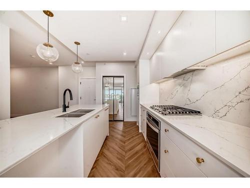 313-8445 Broadcast Avenue Sw, Calgary, AB - Indoor Photo Showing Kitchen With Double Sink With Upgraded Kitchen