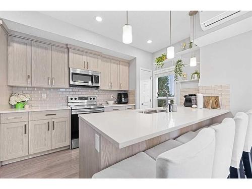 115-4150 Seton Drive, Calgary, AB - Indoor Photo Showing Kitchen With Double Sink