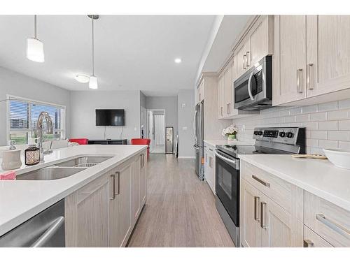 115-4150 Seton Drive, Calgary, AB - Indoor Photo Showing Kitchen With Double Sink With Upgraded Kitchen