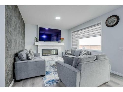 673 Corner Meadows Way Ne, Calgary, AB - Indoor Photo Showing Living Room With Fireplace