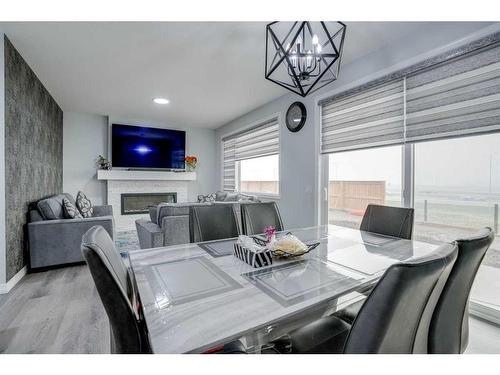 673 Corner Meadows Way Ne, Calgary, AB - Indoor Photo Showing Dining Room With Fireplace