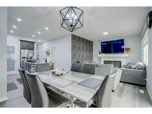 673 Corner Meadows Way Ne, Calgary, AB - Indoor Photo Showing Dining Room With Fireplace