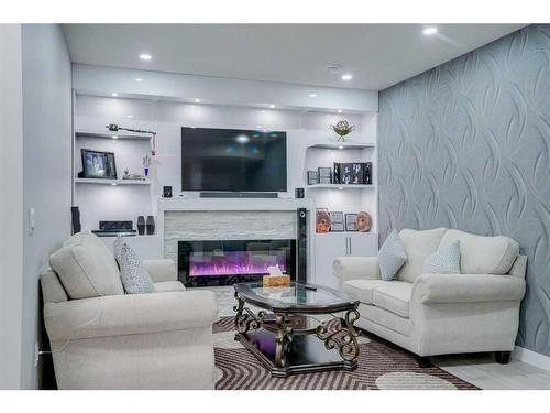 673 Corner Meadows Way Ne, Calgary, AB - Indoor Photo Showing Living Room With Fireplace