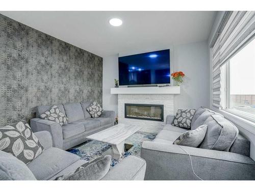 673 Corner Meadows Way Ne, Calgary, AB - Indoor Photo Showing Living Room With Fireplace