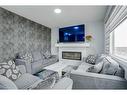 673 Corner Meadows Way Ne, Calgary, AB  - Indoor Photo Showing Living Room With Fireplace 