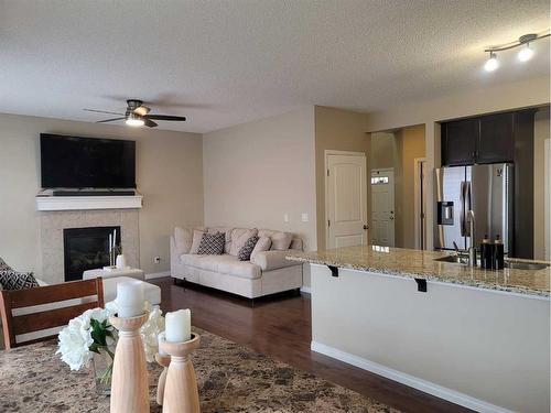 1817 Baywater Gardens Sw, Airdrie, AB - Indoor Photo Showing Living Room With Fireplace