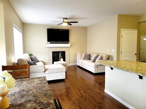 1817 Baywater Gardens Sw, Airdrie, AB - Indoor Photo Showing Living Room With Fireplace