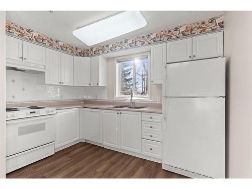 3128-3000 Millrise Point Sw, Calgary, AB - Indoor Photo Showing Kitchen With Double Sink