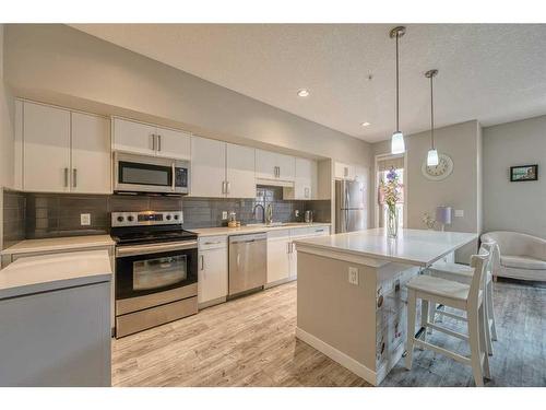 220-7 Westpark Common Sw, Calgary, AB - Indoor Photo Showing Kitchen With Stainless Steel Kitchen