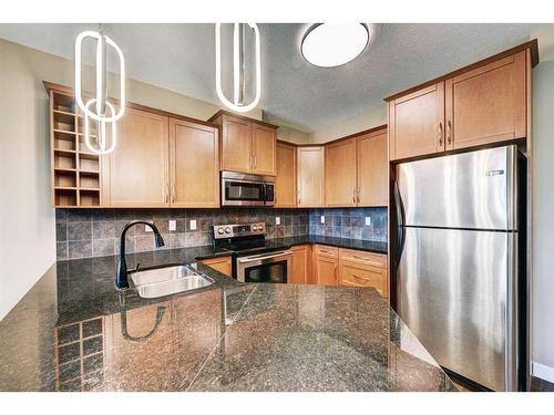 308-35 Aspenmont Heights Sw, Calgary, AB - Indoor Photo Showing Kitchen With Double Sink