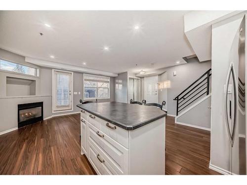 103-6550 Old Banff Coach Road Sw, Calgary, AB - Indoor Photo Showing Kitchen With Fireplace