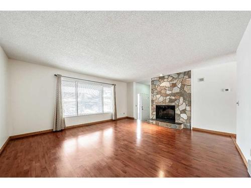 11 Coach Manor Rise Sw, Calgary, AB - Indoor Photo Showing Living Room With Fireplace