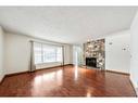 11 Coach Manor Rise Sw, Calgary, AB  - Indoor Photo Showing Living Room With Fireplace 