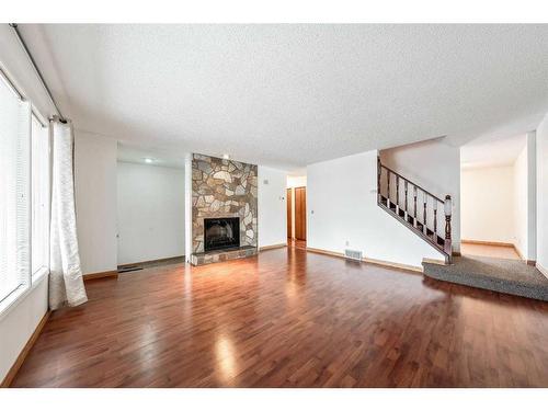 11 Coach Manor Rise Sw, Calgary, AB - Indoor Photo Showing Living Room With Fireplace