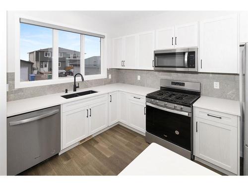 153 Dawson Circle, Chestermere, AB - Indoor Photo Showing Kitchen With Double Sink