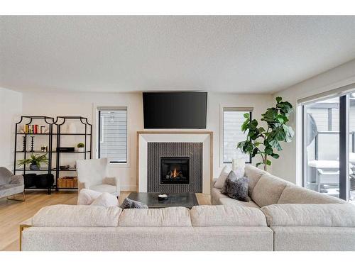 42 Westmore Park Sw, Calgary, AB - Indoor Photo Showing Living Room With Fireplace