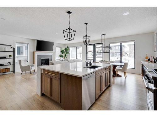 42 Westmore Park Sw, Calgary, AB - Indoor Photo Showing Kitchen With Fireplace