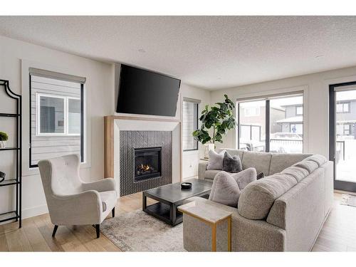 42 Westmore Park Sw, Calgary, AB - Indoor Photo Showing Living Room With Fireplace