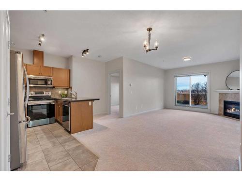 129-52 Cranfield Link Se, Calgary, AB - Indoor Photo Showing Kitchen With Fireplace