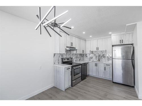 1-1709 48 Street Se, Calgary, AB - Indoor Photo Showing Kitchen With Double Sink