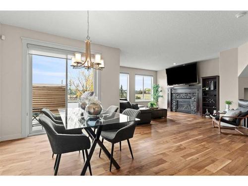 43 Elgin Estates Green Se, Calgary, AB - Indoor Photo Showing Dining Room With Fireplace