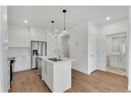 4311-111 Wolf Creek Drive Se, Calgary, AB - Indoor Photo Showing Kitchen With Stainless Steel Kitchen With Double Sink With Upgraded Kitchen