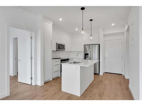 4311-111 Wolf Creek Drive Se, Calgary, AB - Indoor Photo Showing Kitchen With Double Sink With Upgraded Kitchen