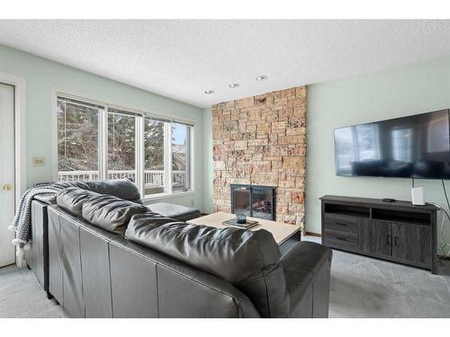 669 Hawkwood Boulevard Nw, Calgary, AB - Indoor Photo Showing Living Room With Fireplace