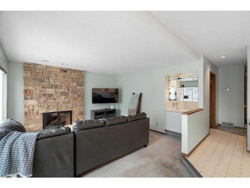 669 Hawkwood Boulevard Nw, Calgary, AB - Indoor Photo Showing Living Room With Fireplace