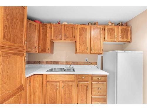 15 Deermont Road Se, Calgary, AB - Indoor Photo Showing Kitchen With Double Sink