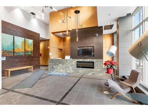 303-550 Riverfront Avenue Se, Calgary, AB - Indoor Photo Showing Other Room With Fireplace