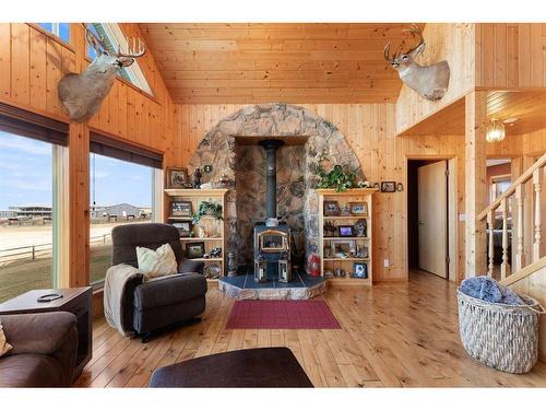 3245 Township Road 292, Rural Mountain View County, AB - Indoor Photo Showing Living Room With Fireplace