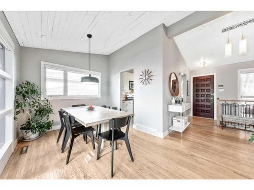 21 Holden Road Sw, Calgary, AB - Indoor Photo Showing Dining Room With Fireplace