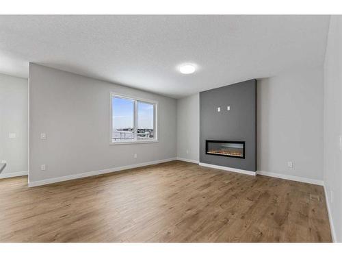 249 Savanna Drive Ne, Calgary, AB - Indoor Photo Showing Living Room With Fireplace