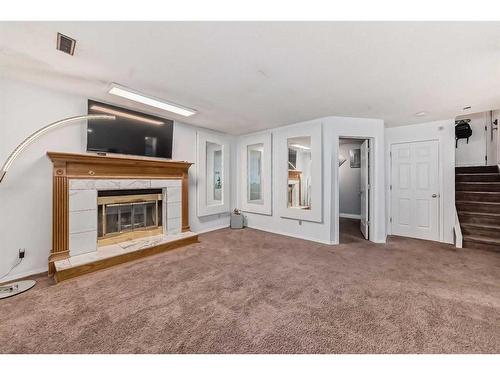 23 Deer Place Se, Calgary, AB - Indoor Photo Showing Living Room With Fireplace