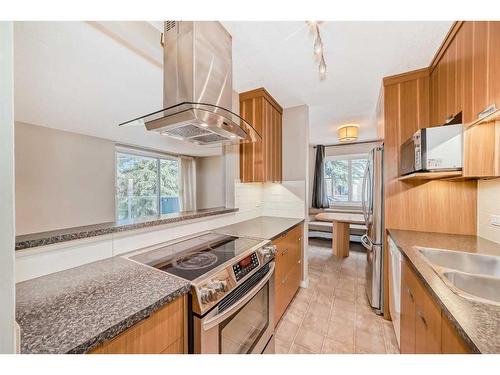 103-312 Cedar Crescent Sw, Calgary, AB - Indoor Photo Showing Kitchen With Double Sink