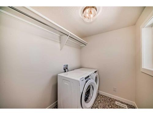 205 Precedence View, Cochrane, AB - Indoor Photo Showing Laundry Room