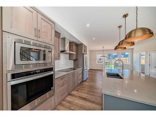 205 Precedence View, Cochrane, AB - Indoor Photo Showing Kitchen With Double Sink With Upgraded Kitchen