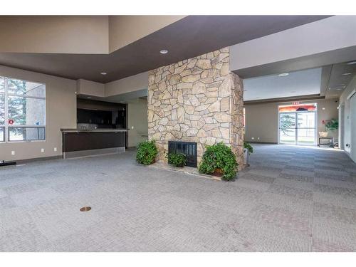 9-122 Village Heights Sw, Calgary, AB - Indoor Photo Showing Living Room With Fireplace