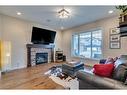 25 Willow Close, Cochrane, AB  - Indoor Photo Showing Living Room With Fireplace 