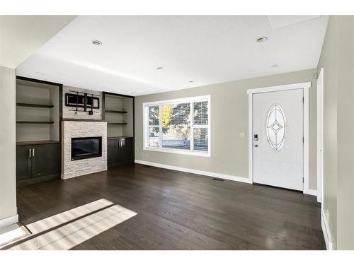 2299 Flanders Avenue Sw, Calgary, AB - Indoor Photo Showing Living Room With Fireplace