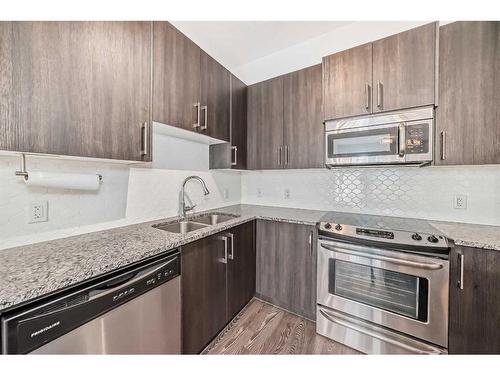 309-4 Sage Hill Terrace Nw, Calgary, AB - Indoor Photo Showing Kitchen With Stainless Steel Kitchen With Double Sink With Upgraded Kitchen