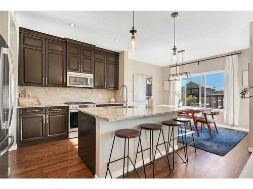 77 Fireside Cove, Cochrane, AB - Indoor Photo Showing Kitchen With Stainless Steel Kitchen With Upgraded Kitchen