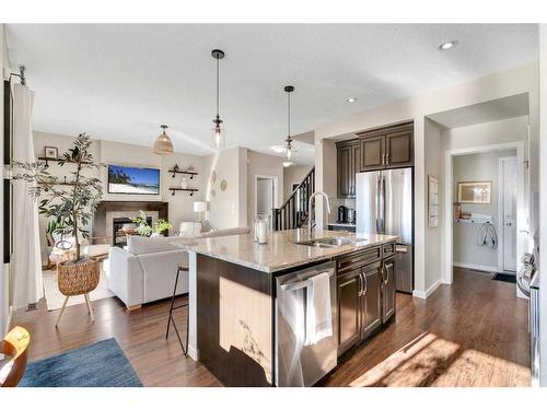 77 Fireside Cove, Cochrane, AB - Indoor Photo Showing Kitchen With Stainless Steel Kitchen With Double Sink With Upgraded Kitchen