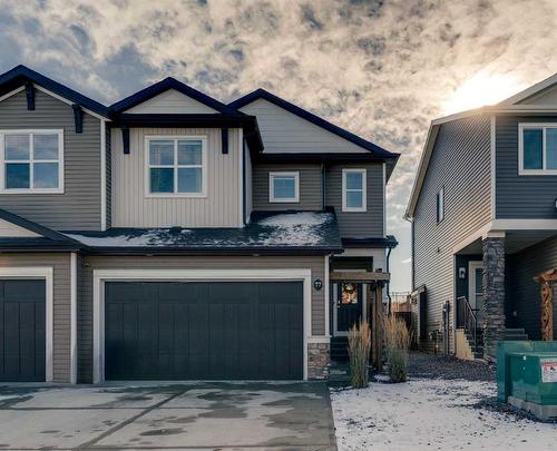 77 Fireside Cove, Cochrane, AB - Outdoor With Facade