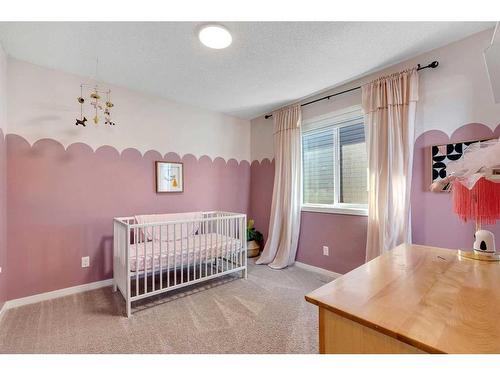 77 Fireside Cove, Cochrane, AB - Indoor Photo Showing Bedroom